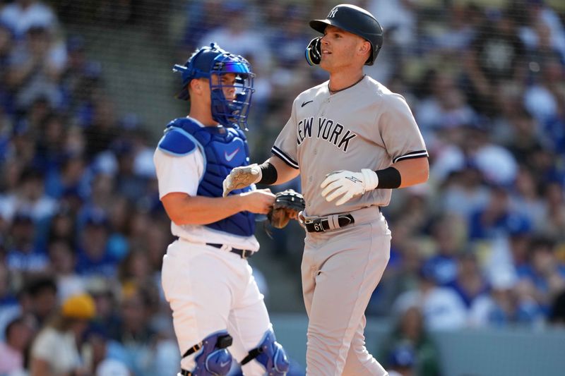 Jun 3, 2023; Los Angeles, California, USA; New York Yankees left fielder Jake Bauers (61) crosses home plate after hitting a home run in the fourth inning as Los Angeles Dodgers catcher Will Smith (16) reacts at Dodger Stadium. Mandatory Credit: Kirby Lee-USA TODAY Sports