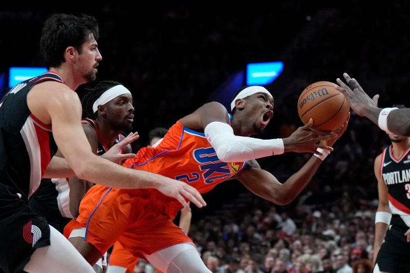 PORTLAND, OREGON - NOVEMBER 01: Shai Gilgeous-Alexander #2 of the Oklahoma City Thunder drives to the basket as he is fouled by Jerami Grant #9 (L) of the Portland Trail Blazers during the first half at Moda Center on November 01, 2024 in Portland, Oregon. NOTE TO USER: User expressly acknowledges and agrees that, by downloading and or using this photograph, User is consenting to the terms and conditions of the Getty Images License Agreement. (Photo by Soobum Im/Getty Images)