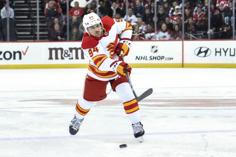 Feb 8, 2024; Newark, New Jersey, USA; Calgary Flames defenseman Brayden Pachal (94) takes a shot against the New Jersey Devils during the first period at Prudential Center. Mandatory Credit: John Jones-USA TODAY Sports