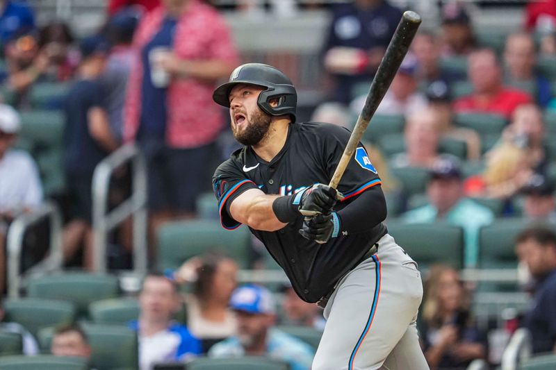 Aug 2, 2024; Cumberland, Georgia, USA; Miami Marlins designated hitter Jake Burger (36) hits a home run against the Atlanta Braves during the third inning at Truist Park. Mandatory Credit: Dale Zanine-USA TODAY Sports