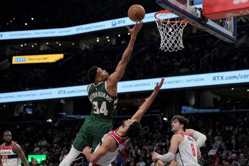 WASHINGTON, DC - APRIL 02: Giannis Antetokounmpo #34 of the Milwaukee Bucks scores against Anthony Gill #16 of the Washington Wizards during the first half at Capital One Arena on April 02, 2024 in Washington, DC. NOTE TO USER: User expressly acknowledges and agrees that, by downloading and or using this photograph, User is consenting to the terms and conditions of the Getty Images License Agreement. (Photo by Jess Rapfogel/Getty Images)