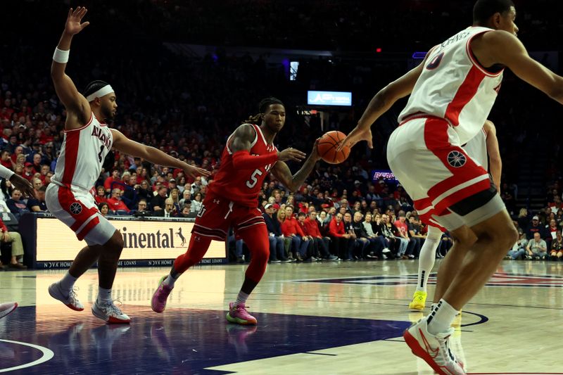 Jan 6, 2024; Tucson, Arizona, USA; Utah Utes guard Deivon Smith (5) makes a pass against Arizona Wildcats guard Kylan Boswell (4) during the first half at McKale Center. Mandatory Credit: Zachary BonDurant-USA TODAY Sports