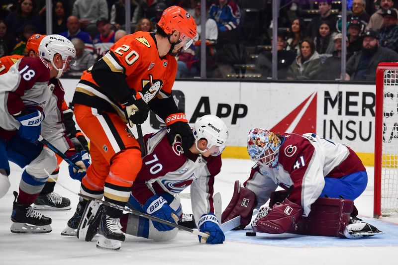 Mar 3, 2026; Anaheim, California, USA; Colorado Avalanche goaltender Scott Wedgewood (41) covers the puck as defenseman Sam Malinski (70) helps defend against Anaheim Ducks left wing Chris Kreider (20) during the second period at Honda Center. Mandatory Credit: Gary A. Vasquez-Imagn Images
