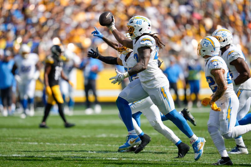 Los Angeles Chargers linebacker Bud Dupree (48) celebrates after intercepting a pass during the second half of an NFL football game against the Pittsburgh Steelers, Sunday, Sept. 22, 2024, in Pittsburgh. (AP Photo/Gene J. Puskar)