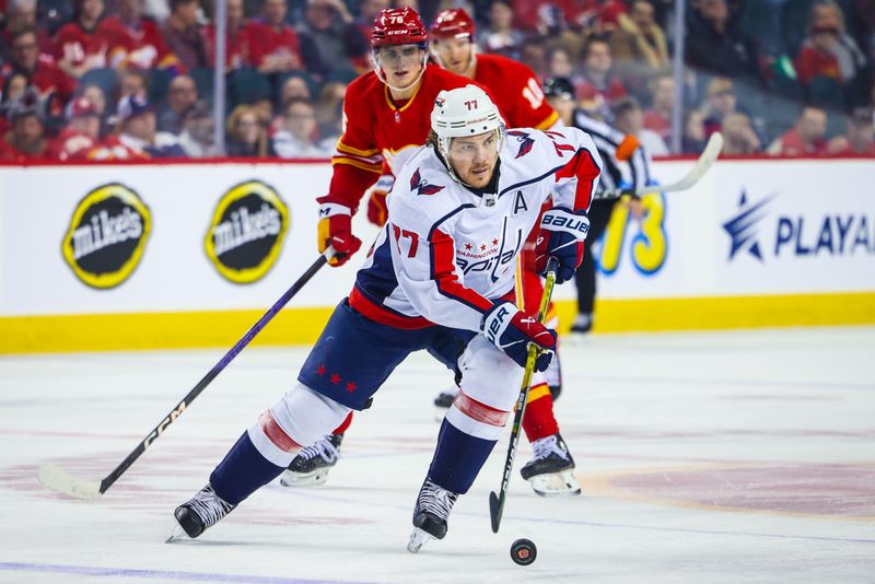 Mar 18, 2024; Calgary, Alberta, CAN; Washington Capitals right wing T.J. Oshie (77) controls the puck against the Calgary Flames during the first period at Scotiabank Saddledome. Mandatory Credit: Sergei Belski-USA TODAY Sports