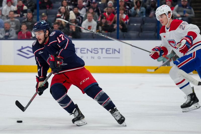 Nov 29, 2023; Columbus, Ohio, USA;  Columbus Blue Jackets right wing Justin Danforth (17) skates with the puck against Montreal Canadiens left wing Juraj Slafkovsky (20) in the first period at Nationwide Arena. Mandatory Credit: Aaron Doster-USA TODAY Sports