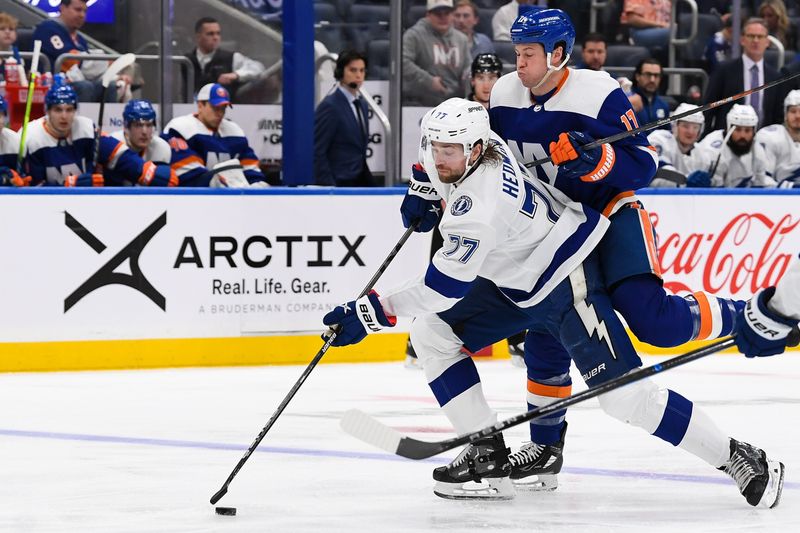 Apr 6, 2023; Elmont, New York, USA; Tampa Bay Lightning defenseman Victor Hedman (77) skates with the puck defended by New York Islanders left wing Matt Martin (17) during the second period at UBS Arena. Mandatory Credit: Dennis Schneidler-USA TODAY Sports