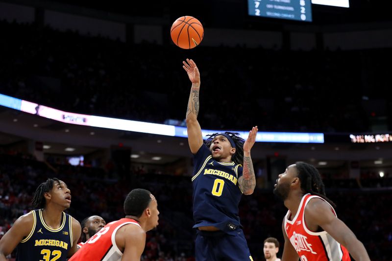 Mar 3, 2024; Columbus, Ohio, USA; Michigan Wolverines guard Dug McDaniel (0) drives to the basket as Ohio State Buckeyes guard Evan Mahaffey (12) defends during the first half at Value City Arena. Mandatory Credit: Joseph Maiorana-USA TODAY Sports