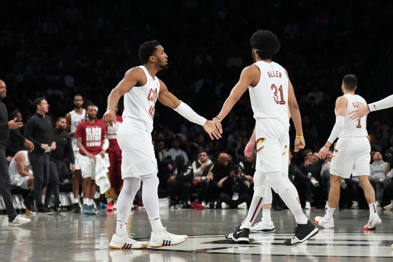 BROOKLYN, NY - FEBRUARY 8: Donovan Mitchell #45 and Jarrett Allen #31 of the Cleveland Cavaliers high five during the game against the Brooklyn Nets on February 8, 2024 at Barclays Center in Brooklyn, New York. NOTE TO USER: User expressly acknowledges and agrees that, by downloading and or using this Photograph, user is consenting to the terms and conditions of the Getty Images License Agreement. Mandatory Copyright Notice: Copyright 2024 NBAE (Photo by Jesse D. Garrabrant/NBAE via Getty Images)