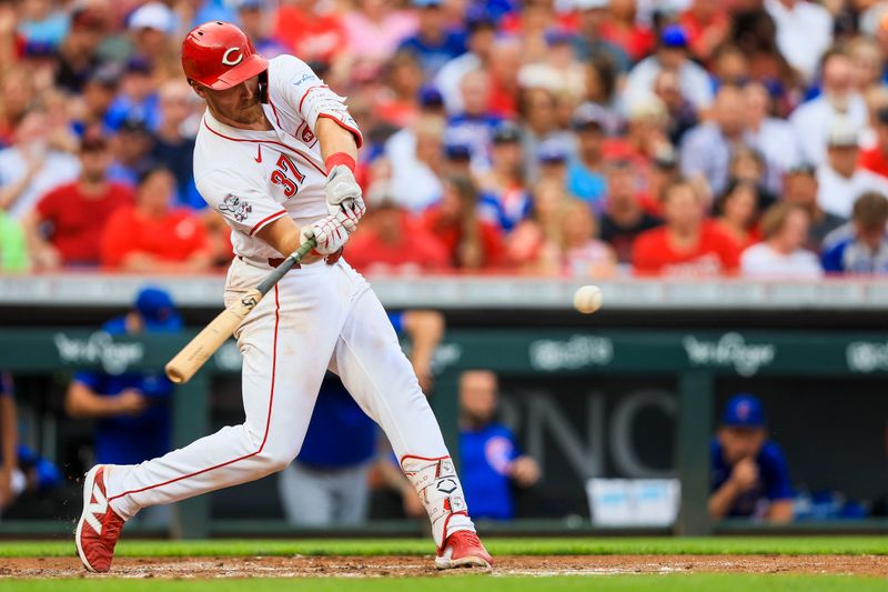 Jul 30, 2024; Cincinnati, Ohio, USA; Cincinnati Reds catcher Tyler Stephenson (37) hits a RBI single in the second inning against the Chicago Cubs at Great American Ball Park. Mandatory Credit: Katie Stratman-USA TODAY Sports