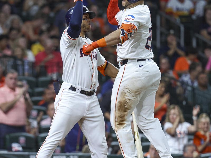 Jul 30, 2024; Houston, Texas, USA; Houston Astros catcher Yainer Diaz (21) celebrates with shortstop Jeremy Pena (3) after hitting a home run during the fourth inning against the Pittsburgh Pirates at Minute Maid Park. Mandatory Credit: Troy Taormina-USA TODAY Sports