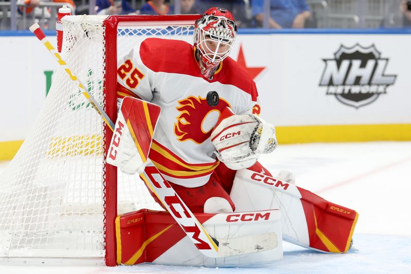 Nov 7, 2022; Elmont, New York, USA; Calgary Flames goaltender Jacob Markstrom (25) plays the puck against the New York Islanders during the second period at UBS Arena. Mandatory Credit: Brad Penner-USA TODAY Sports