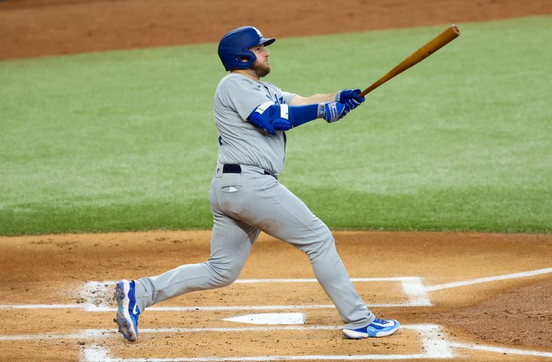 Jul 23, 2023; Arlington, Texas, USA;  Los Angeles Dodgers third baseman Max Muncy (13) hits a grand slam during the first inning against the Texas Rangers at Globe Life Field. Mandatory Credit: Kevin Jairaj-USA TODAY Sports