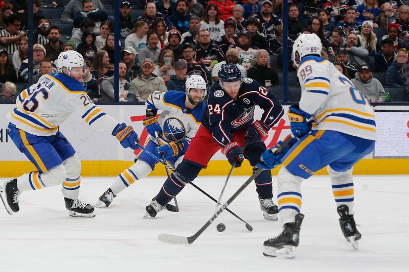 Apr 10, 2025; Columbus, Ohio, USA; Columbus Blue Jackets center Mathieu Olivier (24) carries the puck as Buffalo Sabres defenseman Rasmus Dahlin (26) defends during the second period at Nationwide Arena. Mandatory Credit: Russell LaBounty-Imagn Images