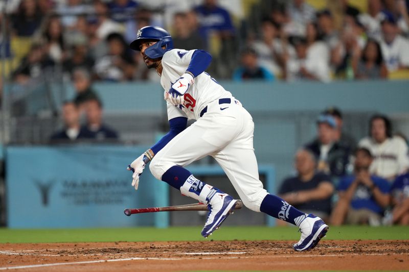 Aug 21, 2024; Los Angeles, California, USA; Los Angeles Dodgers right fielder Mookie Betts (50) hits a two-run double in the third inning against the Seattle Mariners at Dodger Stadium. Mandatory Credit: Kirby Lee-USA TODAY Sports