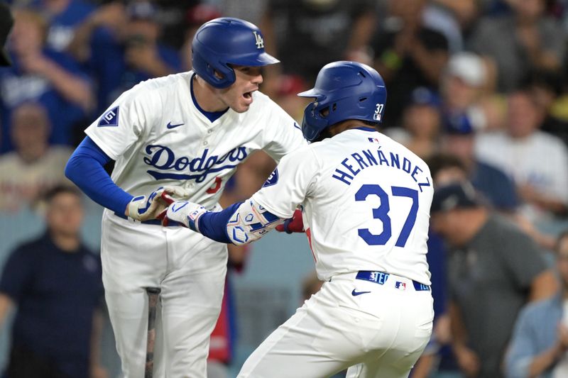 Aug 5, 2024; Los Angeles, California, USA;   Los Angeles Dodgers left fielder Teoscar Hernandez (37) celebrates with first baseman Freddie Freeman (5) after hitting a two-run home run in the third inning against the Philadelphia Phillies at Dodger Stadium. Mandatory Credit: Jayne Kamin-Oncea-USA TODAY Sports