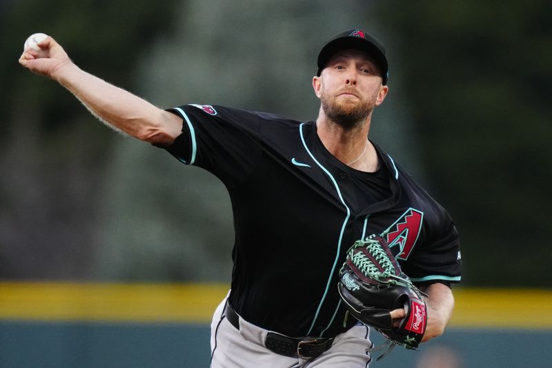 Apr 9, 2024; Denver, Colorado, USA; Arizona Diamondbacks starting pitcher Merrill Kelly (29) delivers a pitch in the first inning against the Colorado Rockies at Coors Field. Mandatory Credit: Ron Chenoy-USA TODAY Sports