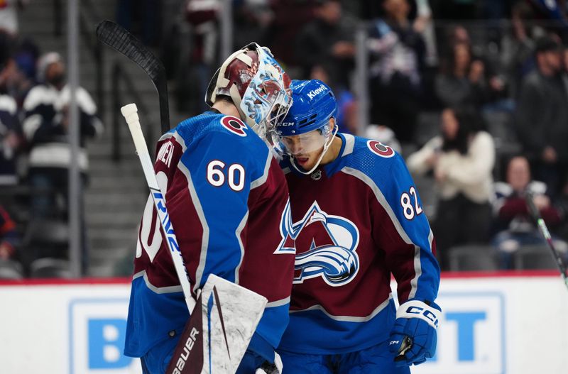 Apr 18, 2024; Denver, Colorado, USA; Colorado Avalanche goaltender Justus Annunen (60) and defenseman Caleb Jones (82) celebrate defeating the Edmonton Oilers at Ball Arena. Mandatory Credit: Ron Chenoy-USA TODAY Sports