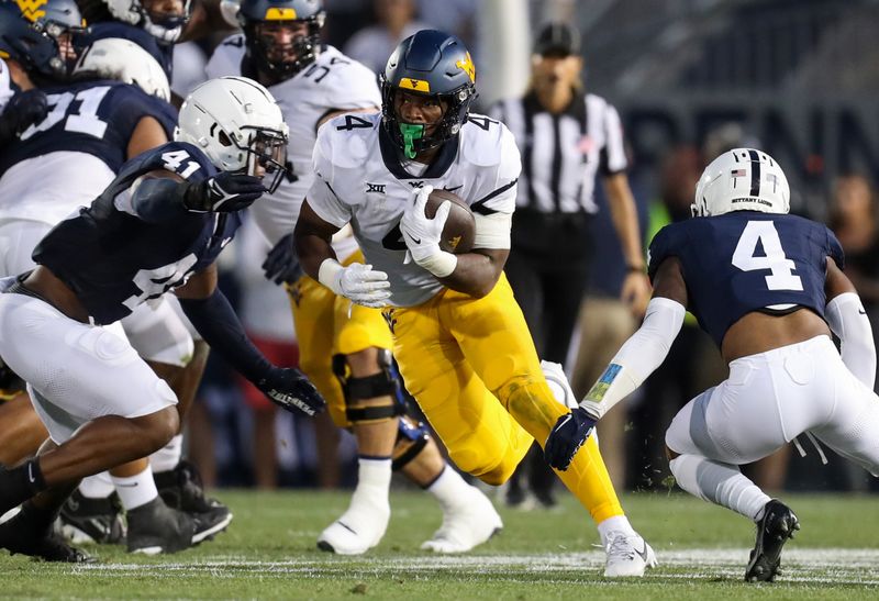 Sep 2, 2023; University Park, Pennsylvania, USA; West Virginia Mountaineers running back CJ Donaldson Jr. (4) runs the ball against the Penn State Nittany Lions during the first quarter at Beaver Stadium. Mandatory Credit: Matthew O'Haren-USA TODAY Sports