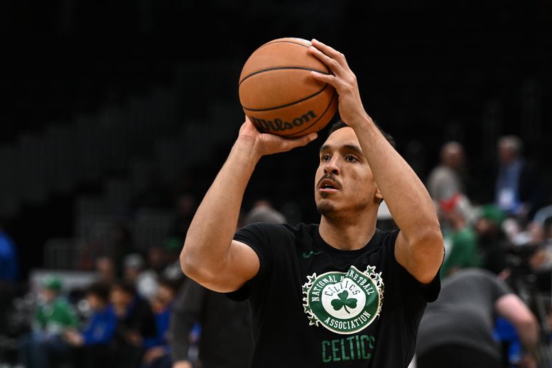 BOSTON, MASSACHUSETTS - DECEMBER 18: Malcolm Brogdon #13 of the Boston Celtics shoots the ball during warmups before a game against the Orlando Magic at the TD Garden on December 18, 2022 in Boston, Massachusetts. NOTE TO USER: User expressly acknowledges and agrees that, by downloading and or using this photograph, User is consenting to the terms and conditions of the Getty Images License Agreement. (Photo by Brian Fluharty/Getty Images)