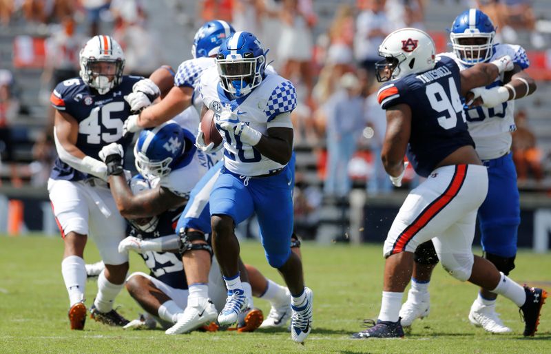 Sep 26, 2020; Auburn, Alabama, USA;  Kentucky Wildcats running back Kavosiey Smoke (20) gets past Auburn Tigers defenders and scores a touchdown during the first quarter at Jordan-Hare Stadium. Mandatory Credit: John Reed-USA TODAY Sports