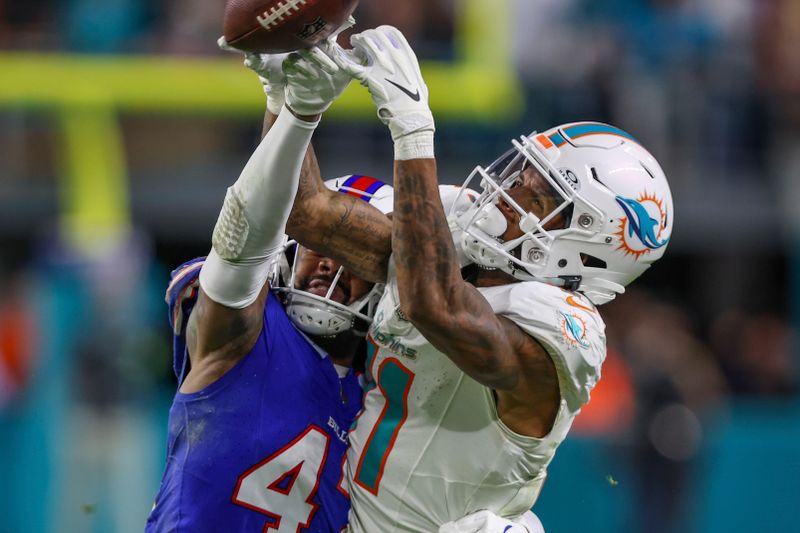 Buffalo Bills cornerback Christian Benford (47) knock a pass away from Miami Dolphins wide receiver Cedrick Wilson Jr. (11), right, during an NFL football game, Sunday, Jan. 7, 2024, in Miami Gardens, Fla. The Bills defeated the Dolphins 21-14. (AP Photo/Gary McCullough)