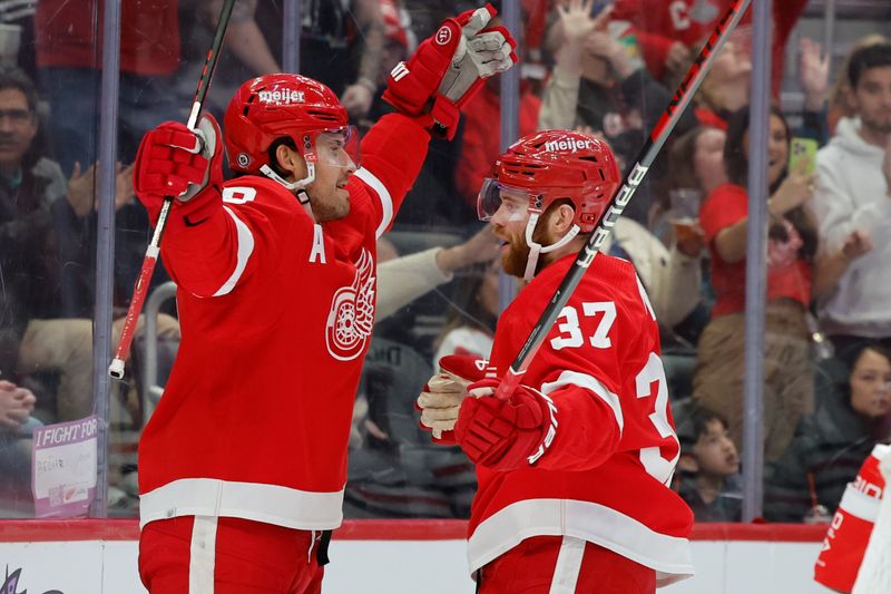 Nov 30, 2023; Detroit, Michigan, USA; Detroit Red Wings defenseman Ben Chiarot (8) receives congratulations from left wing J.T. Compher (37) after scoring in the second period against the Chicago Blackhawks at Little Caesars Arena. Mandatory Credit: Rick Osentoski-USA TODAY Sports