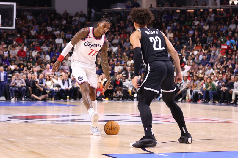 OCEANSIDE, CALIFORNIA - OCTOBER 08: Kevin Porter Jr. #77 of the Los Angeles Clippers tries to move past Jalen Wilson #22 of the Brooklyn Nets in the first quarter of the preseason game at Frontwave Arena on October 08, 2024 in Oceanside, California. NOTE TO USER: User expressly acknowledges and agrees that, by downloading and or using this photograph, User is consenting to the terms and conditions of the Getty Images License Agreement. (Photo by Joe Scarnici/Getty Images)