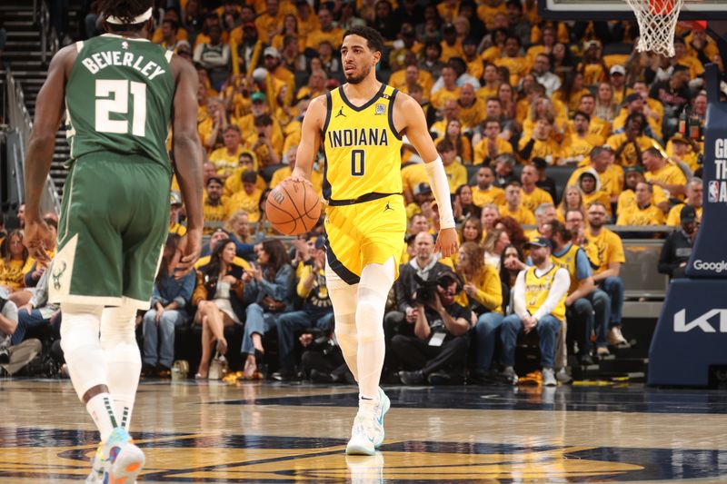 INDIANAPOLIS, IN - APRIL 26: Tyrese Haliburton #0 of the Indiana Pacers dribbles the ball during the game against the Milwaukee Bucks during Round 1 Game 3 of the 2024 NBA Playoffs on April 26, 2024 at Gainbridge Fieldhouse in Indianapolis, Indiana. NOTE TO USER: User expressly acknowledges and agrees that, by downloading and or using this Photograph, user is consenting to the terms and conditions of the Getty Images License Agreement. Mandatory Copyright Notice: Copyright 2023 NBAE (Photo by Nathaniel S. Butler/NBAE via Getty Images)