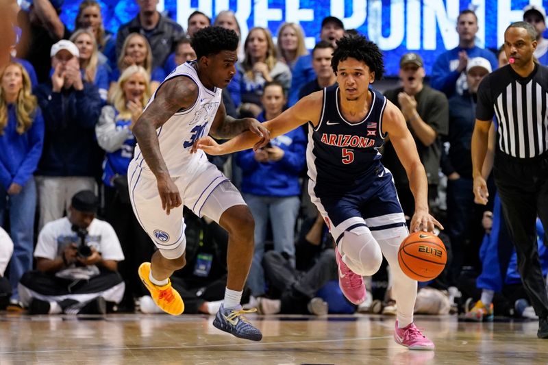Jan 26, 2026; Provo, Utah, USA; Arizona Wildcats guard Brayden Burries (5) drives while being defended by BYU Cougars forward Kennard Davis Jr. (30) during the second half at Marriott Center. Mandatory Credit: Aaron Baker-Imagn Images 