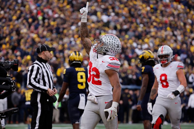 Nov 25, 2023; Ann Arbor, Michigan, USA; Ohio State Buckeyes running back TreVeyon Henderson (32) celebrates after he scores a touchdown in the second half against the Michigan Wolverines at Michigan Stadium. Mandatory Credit: Rick Osentoski-USA TODAY Sports