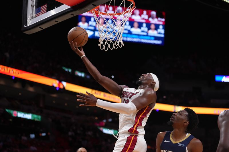 MIAMI, FL - OCTOBER 13:  Bam Adebayo #13 of the Miami Heat shoots the ball during the game against the New Orleans Pelicans during a preseason game on October 13, 2024 at Kaseya Center in Miami, Florida. NOTE TO USER: User expressly acknowledges and agrees that, by downloading and or using this Photograph, user is consenting to the terms and conditions of the Getty Images License Agreement. Mandatory Copyright Notice: Copyright 2024 NBAE (Photo by Eric Espada/NBAE via Getty Images)