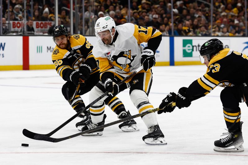 Nov 29, 2024; Boston, Massachusetts, USA; Pittsburgh Penguins right wing Bryan Rust (17) tries to get between Boston Bruins right wing David Pastrnak (88) and defenseman Charlie McAvoy (73) during the second period at TD Garden. Mandatory Credit: Winslow Townson-Imagn Images