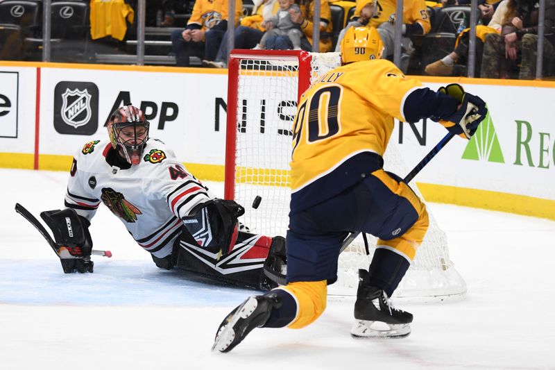 Jan 2, 2024; Nashville, Tennessee, USA; Nashville Predators center Ryan O'Reilly (90) scores against Chicago Blackhawks goaltender Arvid Soderblom (40) during the third period at Bridgestone Arena. Mandatory Credit: Christopher Hanewinckel-USA TODAY Sports