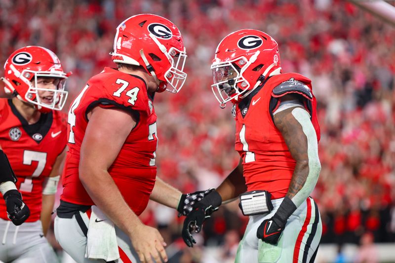 Oct 12, 2024; Athens, Georgia, USA; Georgia Bulldogs running back Trevor Etienne (1) celebrates after a touchdown with offensive lineman Drew Bobo (74) against the Mississippi State Bulldogs in the fourth quarter at Sanford Stadium. Mandatory Credit: Brett Davis-Imagn Images
