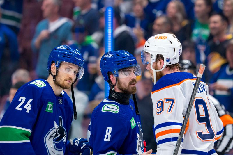 May 20, 2024; Vancouver, British Columbia, CAN; Vancouver Canucks forward Pius Suter (24) and forward Conor Garland (8) shake hands with Edmonton Oilers forward Connor McDavid (97) after the Edmonton victory in game seven of the second round of the 2024 Stanley Cup Playoffs at Rogers Arena. Mandatory Credit: Bob Frid-USA TODAY Sports