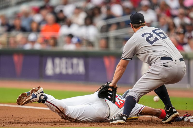 Aug 15, 2023; Cumberland, Georgia, USA; A pickoff throw gets past New York Yankees first baseman DJ LeMahieu (26) allowing Atlanta Braves right fielder Ronald Acuna Jr. (13) to advance to third base during the first inning at Truist Park. Mandatory Credit: Dale Zanine-USA TODAY Sports