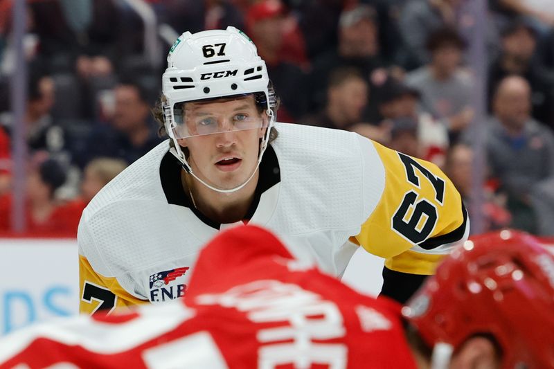 Oct 18, 2023; Detroit, Michigan, USA; Pittsburgh Penguins right wing Rickard Rakell (67) gets set during a face off in the first period against the Detroit Red Wings at Little Caesars Arena. Mandatory Credit: Rick Osentoski-USA TODAY Sports