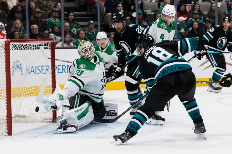 Mar 5, 2024; San Jose, California, USA; San Jose Sharks right wing Filip Zadina (18) scores a goal against Dallas Stars goaltender Jake Oettinger (29) during the second period at SAP Center at San Jose. Mandatory Credit: John Hefti-USA TODAY Sports