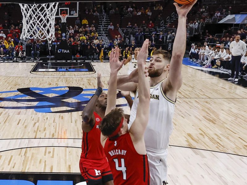 Mar 9, 2023; Chicago, IL, USA; Michigan Wolverines center Hunter Dickinson (1) shoots against Rutgers Scarlet Knights guard Paul Mulcahy (4) during the first half at United Center. Mandatory Credit: Kamil Krzaczynski-USA TODAY Sports