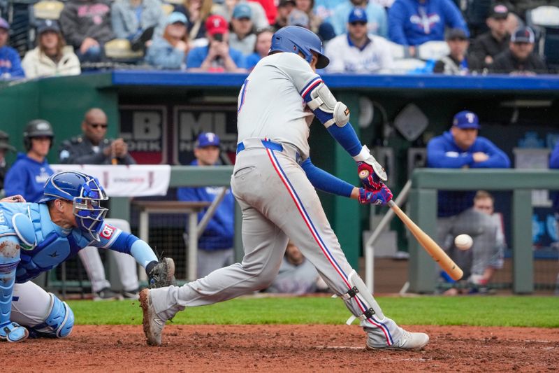 May 5, 2024; Kansas City, Missouri, USA; Texas Rangers first baseman Nathaniel Lowe (30) hits the game winning single against the Kansas City Royals in the tenth inning at Kauffman Stadium. Mandatory Credit: Denny Medley-USA TODAY Sports