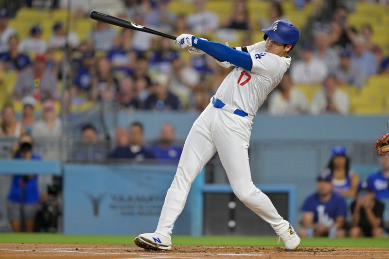 Sep 6, 2024; Los Angeles, California, USA;  Los Angeles Dodgers designated hitter Shohei Ohtani (17) hits a long fly ball for an out in the first inning against the Cleveland Guardians at Dodger Stadium. Mandatory Credit: Jayne Kamin-Oncea-Imagn Images