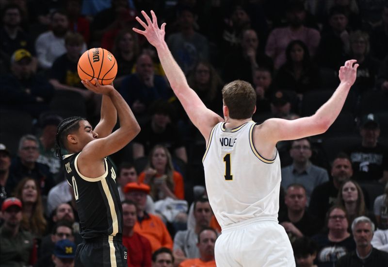 Mar 14, 2025; Indianapolis, IN, USA; Purdue Boilermakers guard C.J. Cox (0) shoots over Michigan Wolverines center Danny Wolf (1) during the first half at Gainbridge Fieldhouse. Mandatory Credit: Robert Goddin-Imagn Images