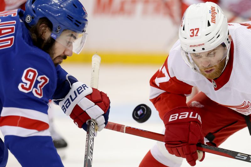 Nov 29, 2023; New York, New York, USA; New York Rangers center Mika Zibanejad (93) and Detroit Red Wings left wing J.T. Compher (37) fight for the puck during a face-off during the third period at Madison Square Garden. Mandatory Credit: Brad Penner-USA TODAY Sports