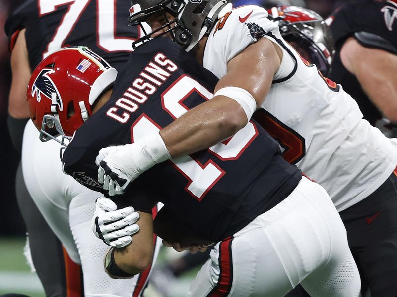 Tampa Bay Buccaneers defensive end Logan Hall (90) sacks Atlanta Falcons quarterback Kirk Cousins (18) during the first half of an NFL football game Thursday, Oct. 3, 2024, in Atlanta. (AP Photo/Butch Dill)