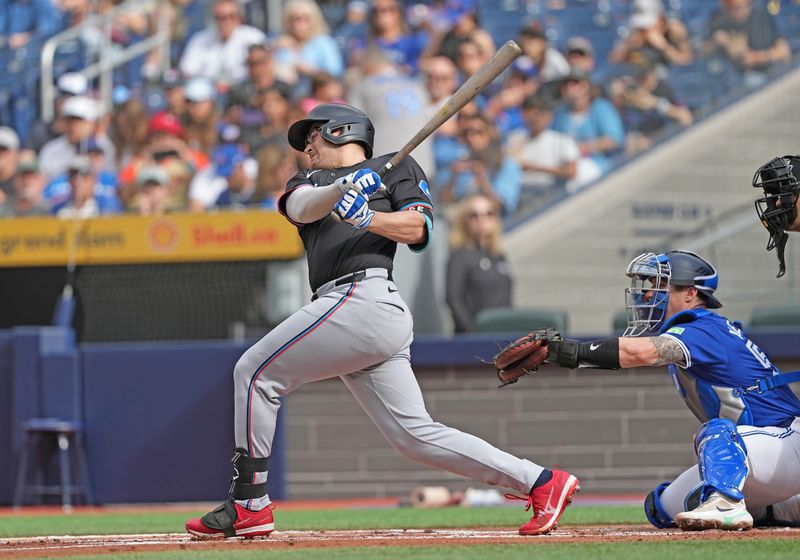 Sep 29, 2024; Toronto, Ontario, CAN; Miami Marlins first baseman Jonah Bride (41) hits a two run single against the Toronto Blue Jays during the first inning at Rogers Centre. Mandatory Credit: Nick Turchiaro-Imagn Images