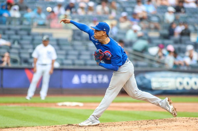 Jul 9, 2023; Bronx, New York, USA;  Chicago Cubs relief pitcher Adbert Alzolay (73) pitches in the ninth inning against the New York Yankees at Yankee Stadium. Mandatory Credit: Wendell Cruz-USA TODAY Sports