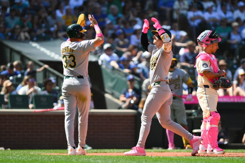 May 12, 2024; Seattle, Washington, USA; Oakland Athletics center fielder JJ Bleday (33) and left fielder Brent Rooker (25) celebrate after Rooker hit a 2-run home run against the Seattle Mariners during the eighth inning at T-Mobile Park. Mandatory Credit: Steven Bisig-USA TODAY Sports