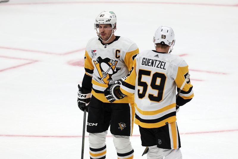 Nov 7, 2023; Anaheim, California, USA; Pittsburgh Penguins center Sidney Crosby (87) is greeted by left wing Jake Guentzel (59) after scoring an empty net goal in the third period against the Anaheim Ducks at Honda Center. Mandatory Credit: Kiyoshi Mio-USA TODAY Sports