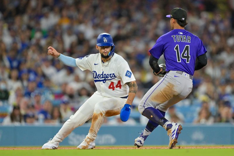 Sep 10, 2025; Los Angeles, California, USA; Colorado Rockies shortstop Ezequiel Tovar (14) attempts to tag Los Angeles Dodgers center fielder Andy Pages (44) on a rundown play in the fourth inning at Dodger Stadium. Mandatory Credit: Jayne Kamin-Oncea-Imagn Images